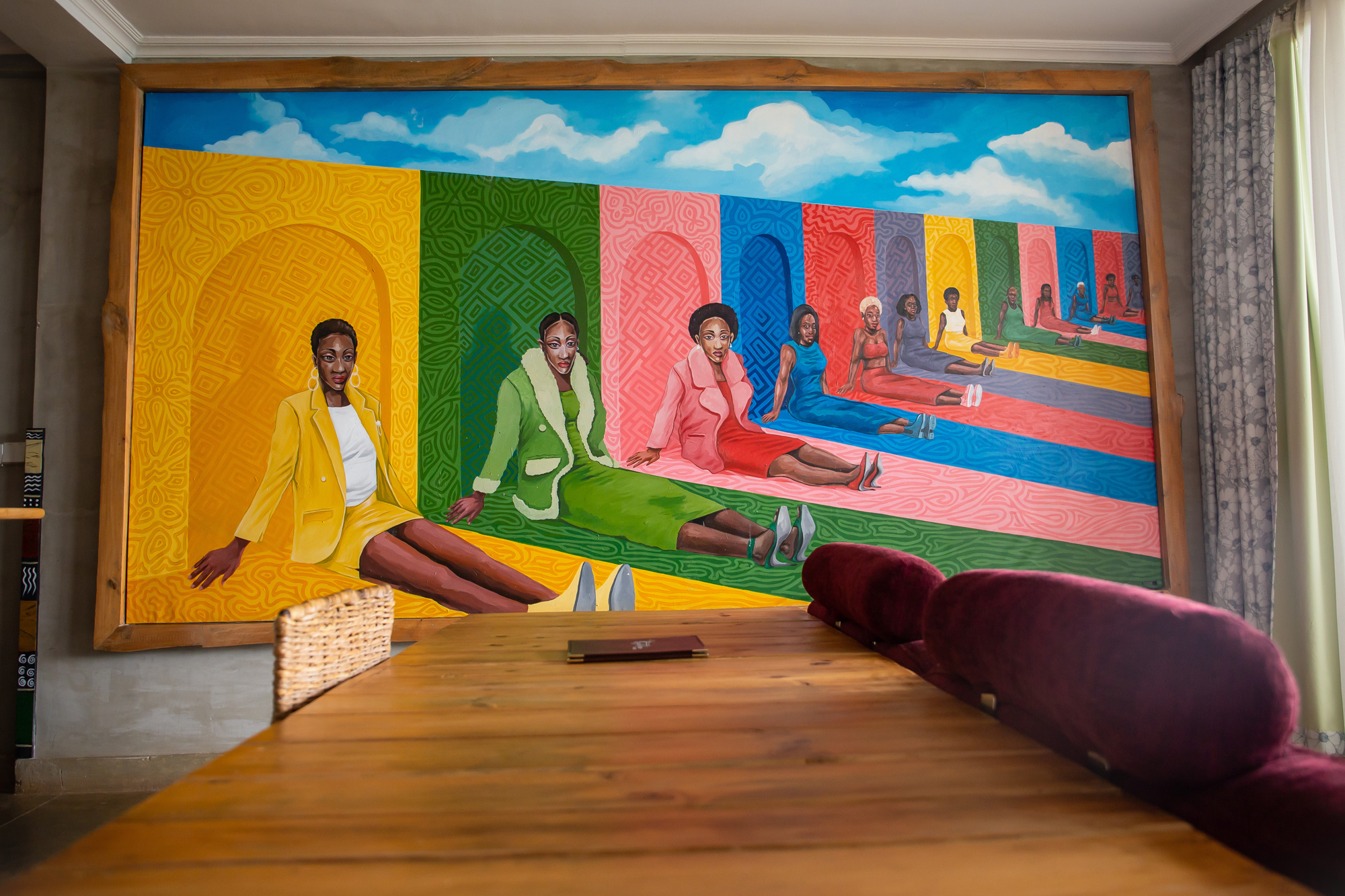 A serene bathroom interior featuring a modern white bathtub next to large glass windows overlooking a lush green forest with a hanging chair and wooden deck.