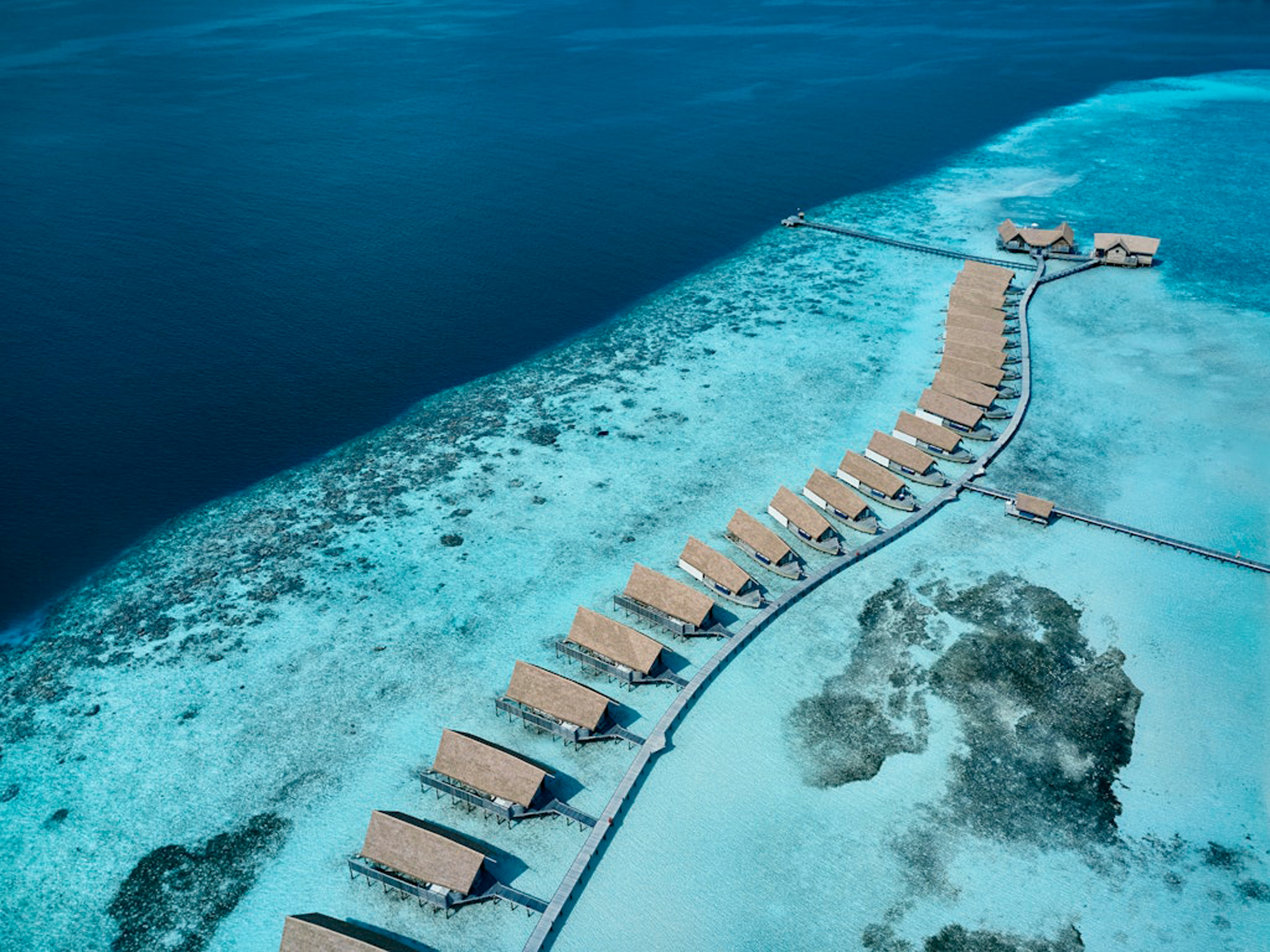 Aerial_Water Villas_Medium Dhoni-inspired over-water villa at COMO Cocoa Island with turquoise lagoon views